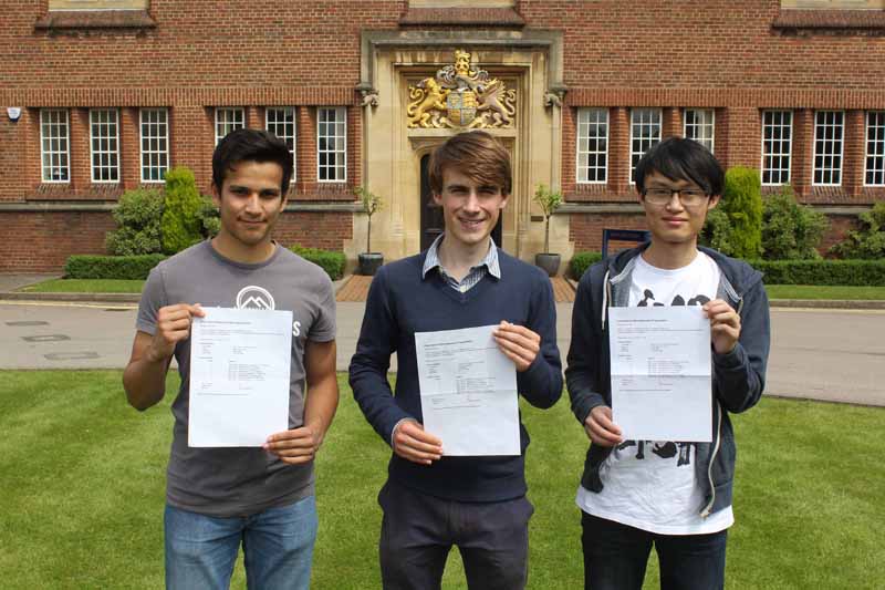 a picture of three students with their IB results