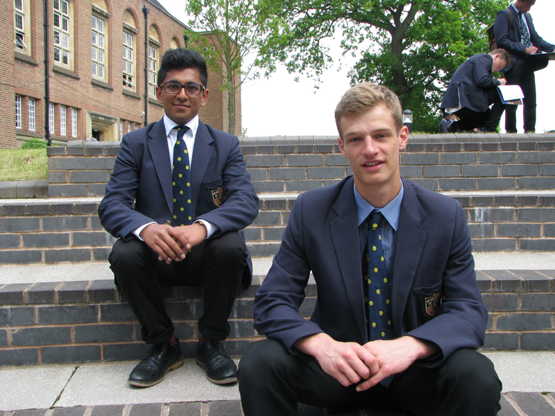 a picture of two students sat on the stairs