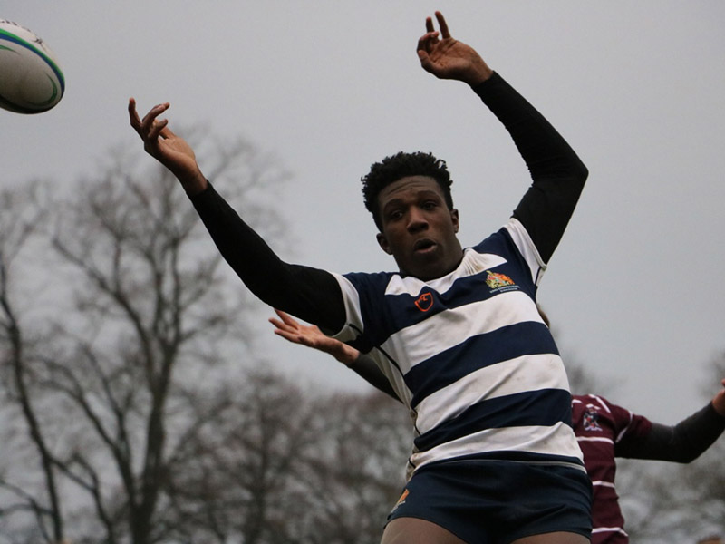 a picture of a student playing rugby