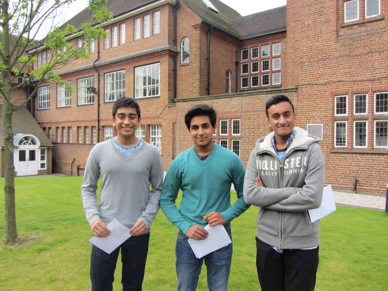 a picture of three students with their GCSE results