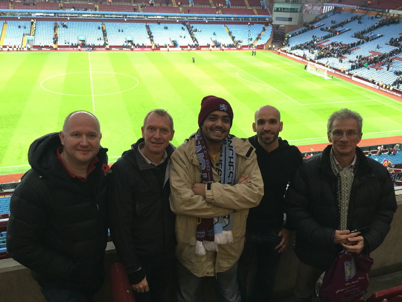 a piucture of five people at a football match