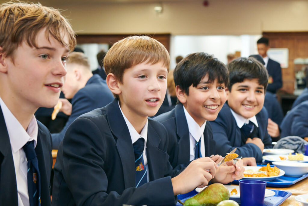 a picture of students eating food in the dinning hall
