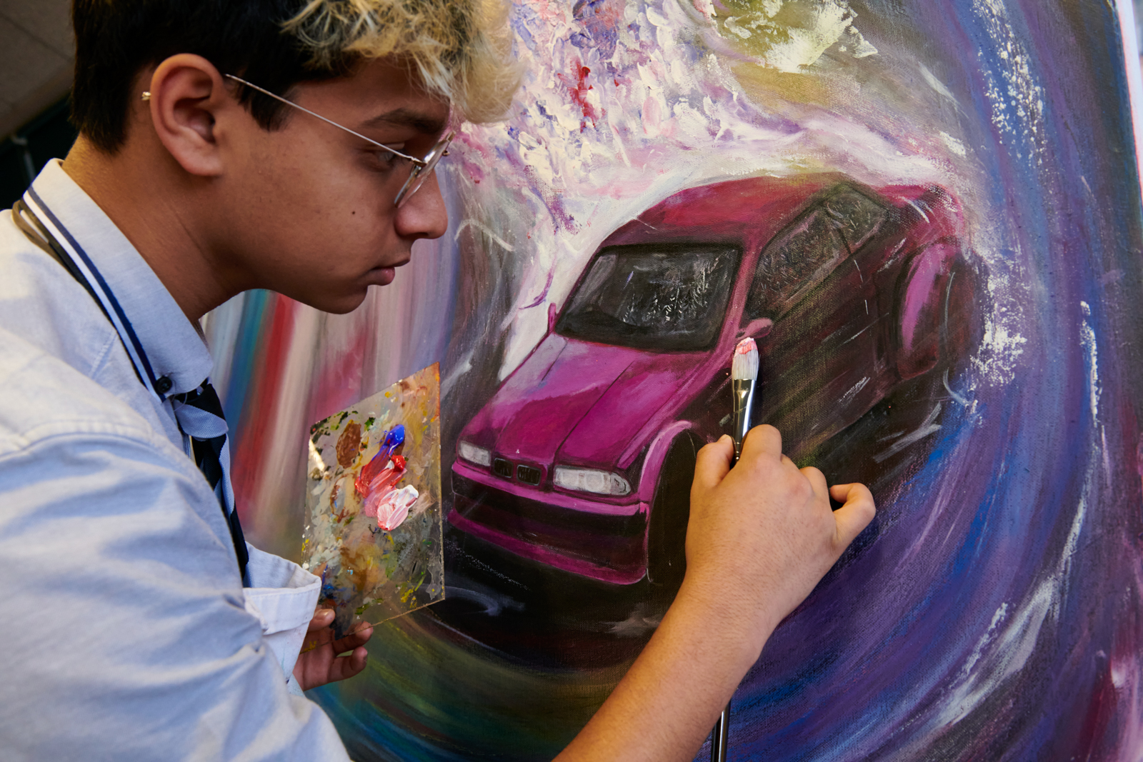 a picture of a student painting on a canvas