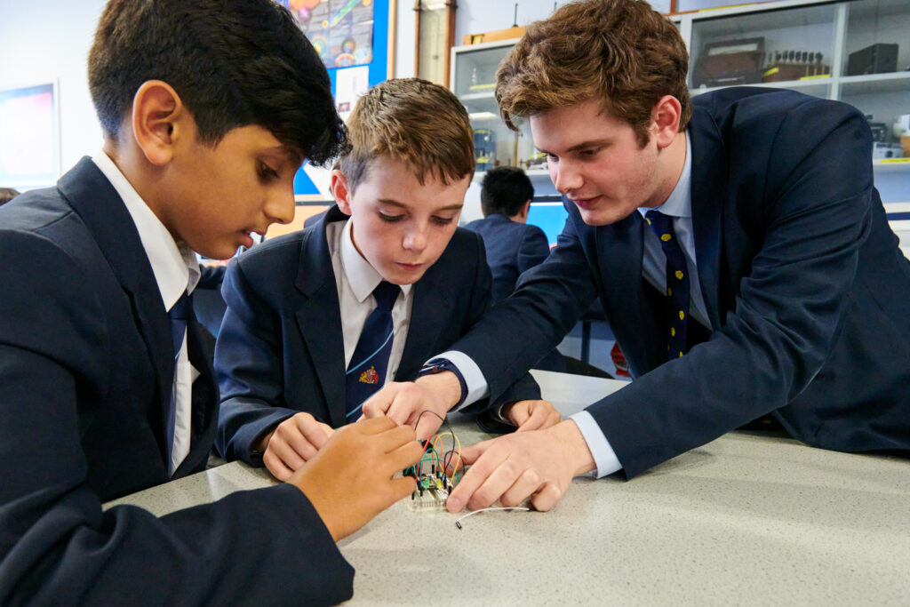 a picture of a group of students working together on a project