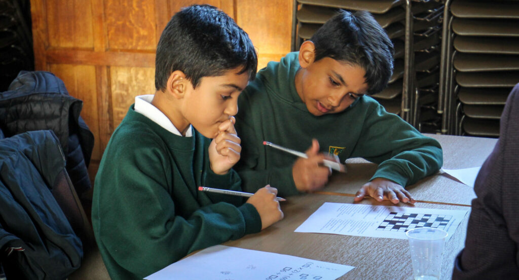 a picture of two year 4 students doing a maths challenge