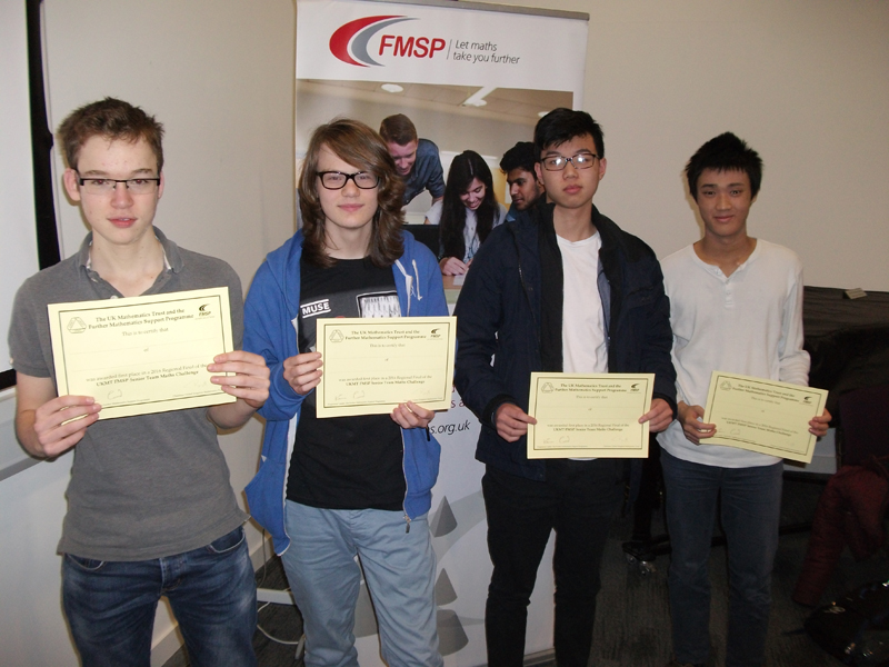 a picture of four students with certificates
