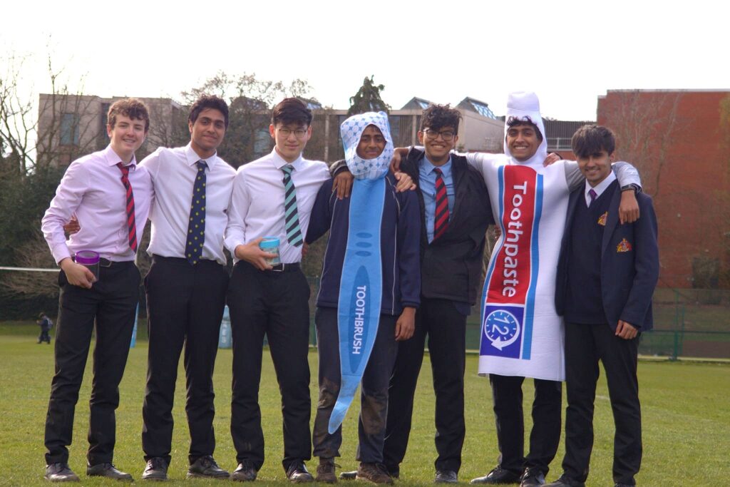 a picture of a group of students with two of them dressed as toothpaste