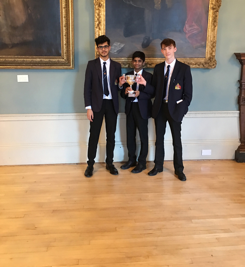 a picture of the public speaking team with their trophy