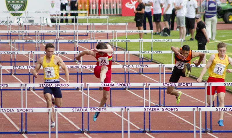 a picture of four people runnung and jumping on the track