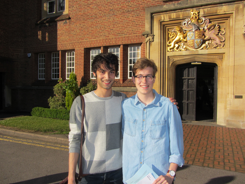 a picture of two students with their results