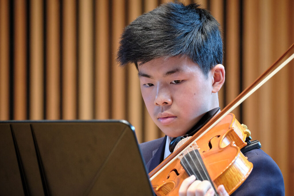 a picture of a student playing the violin