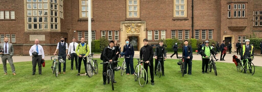 a picture of a group of students and teachers with their bikes