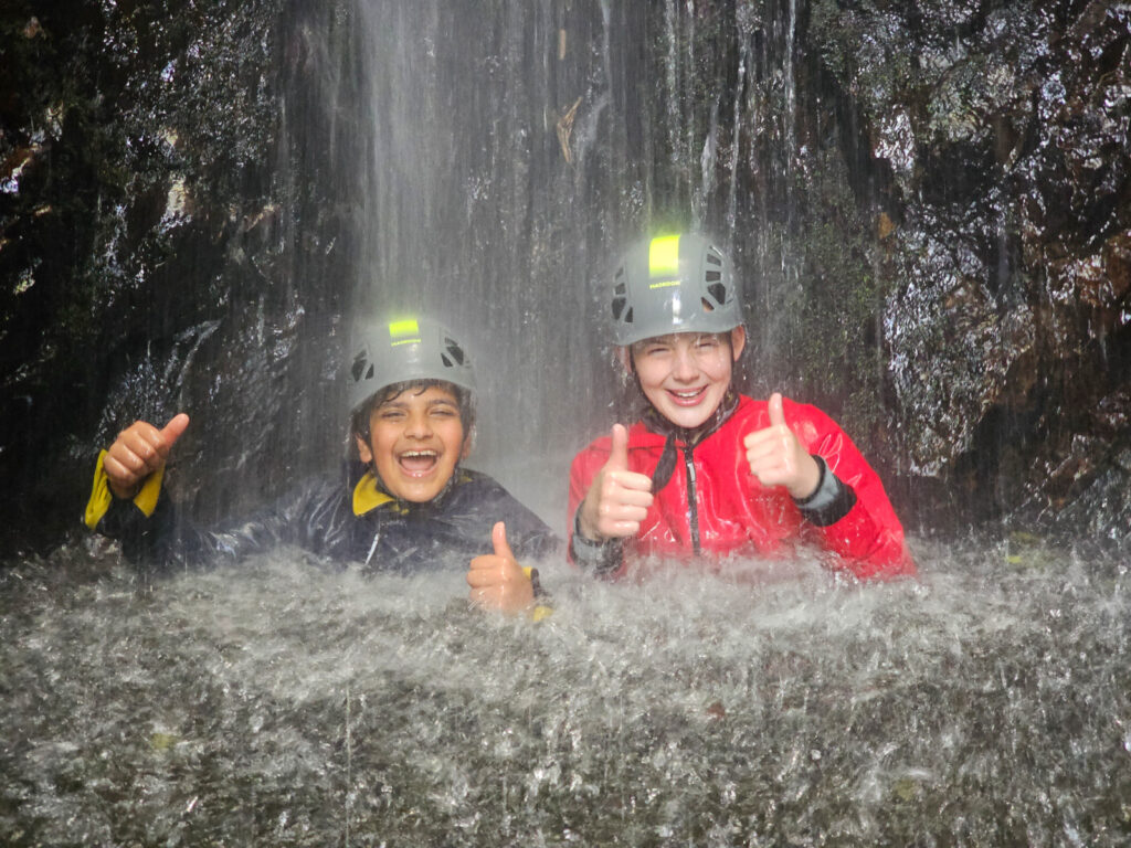 a picture of two students in a waterfall