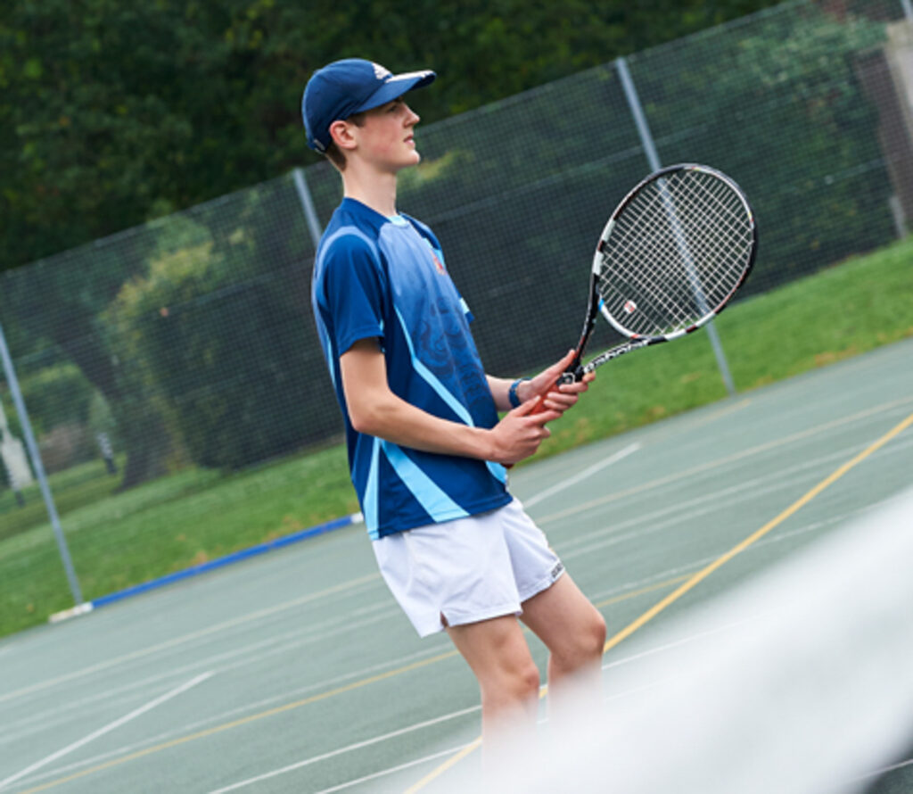 a picture of a student playing tennis