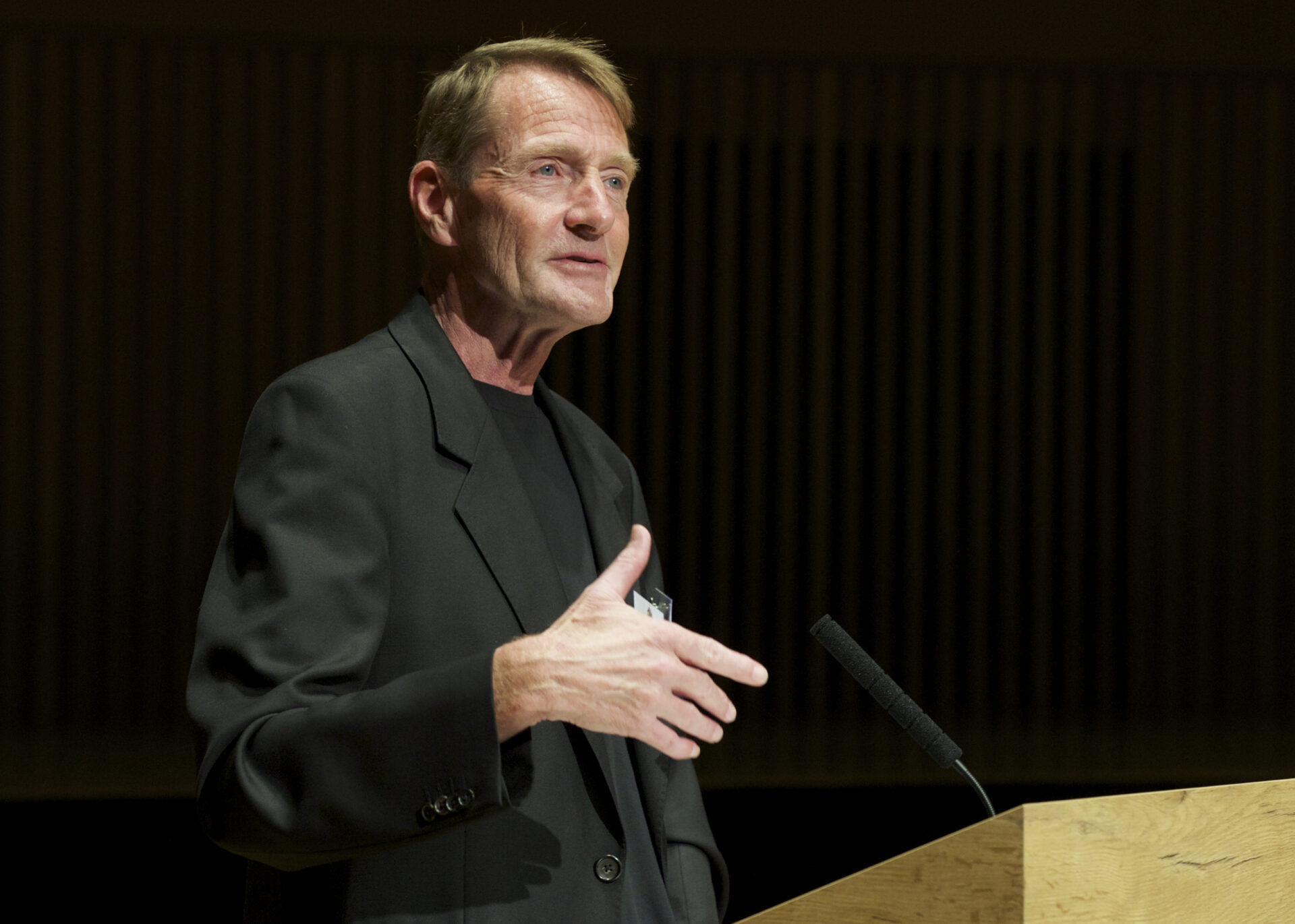 A male speaking at a podium.