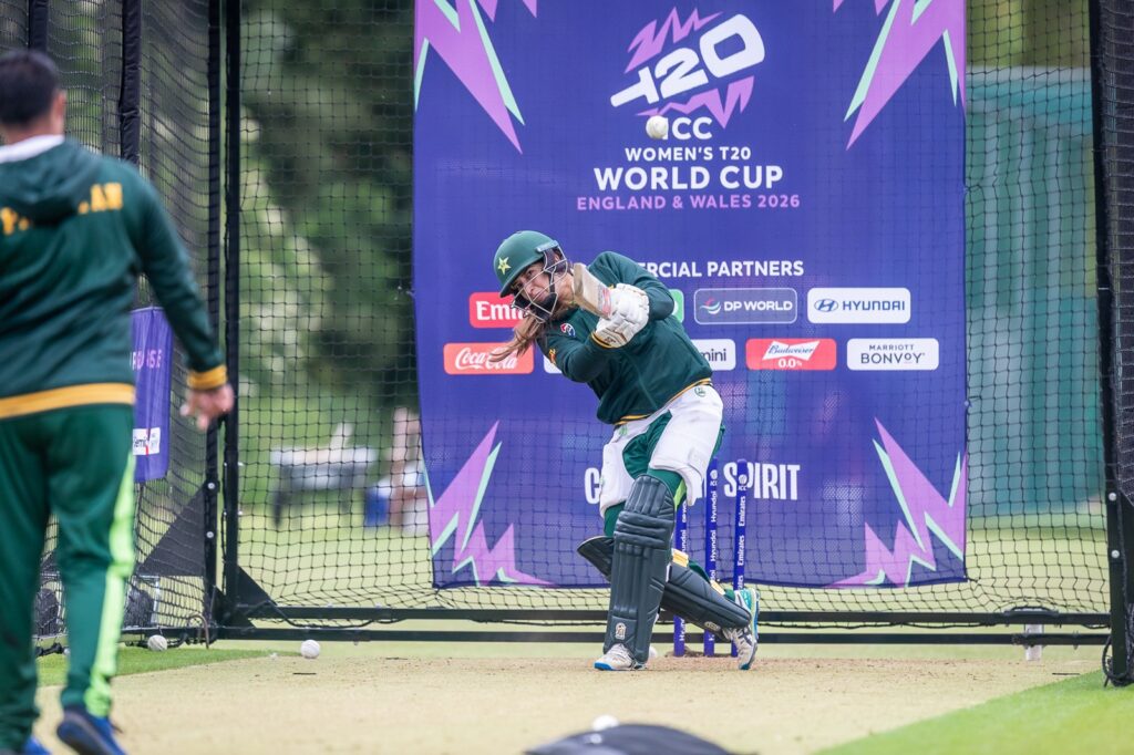Pakistan player with world cup branding behind her, batting