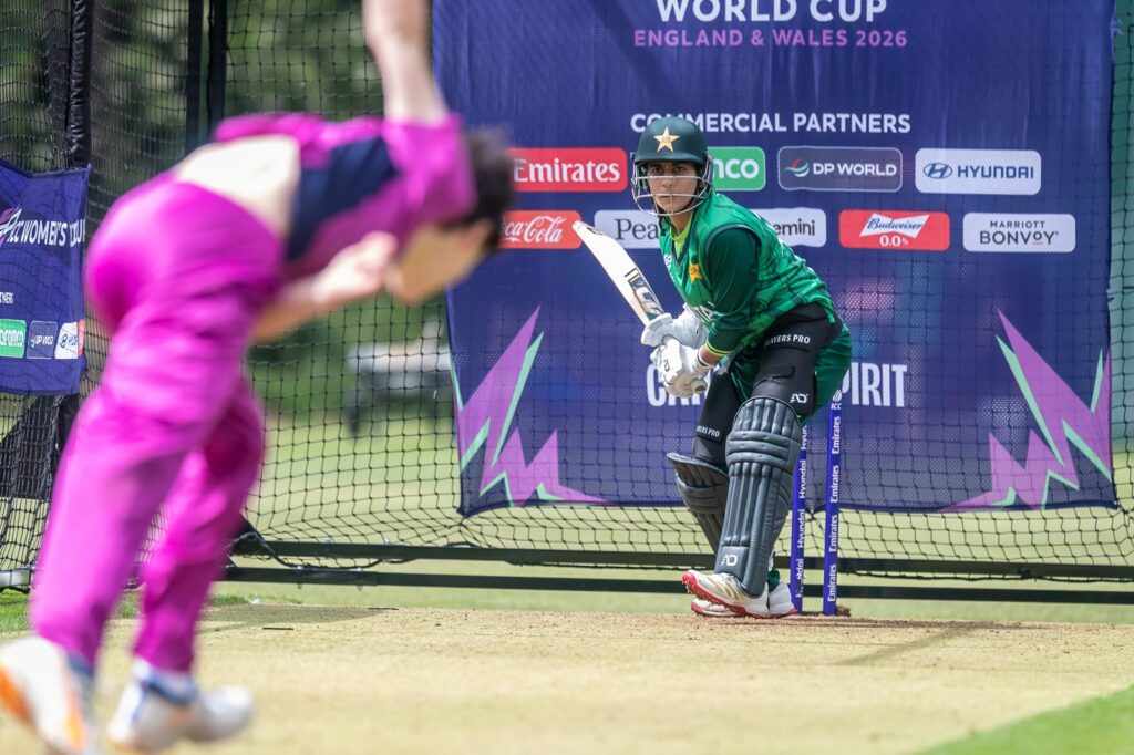Student in purple net bowling kit bowling at Pakistan player