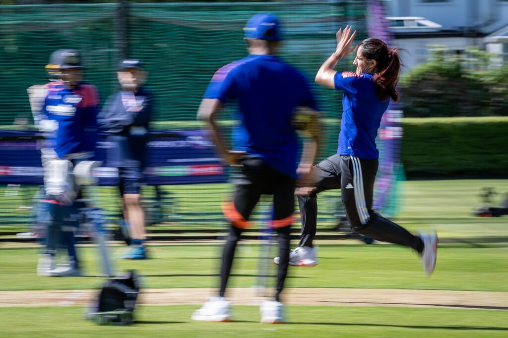 Artistic blurred photo of India player in her bowling action