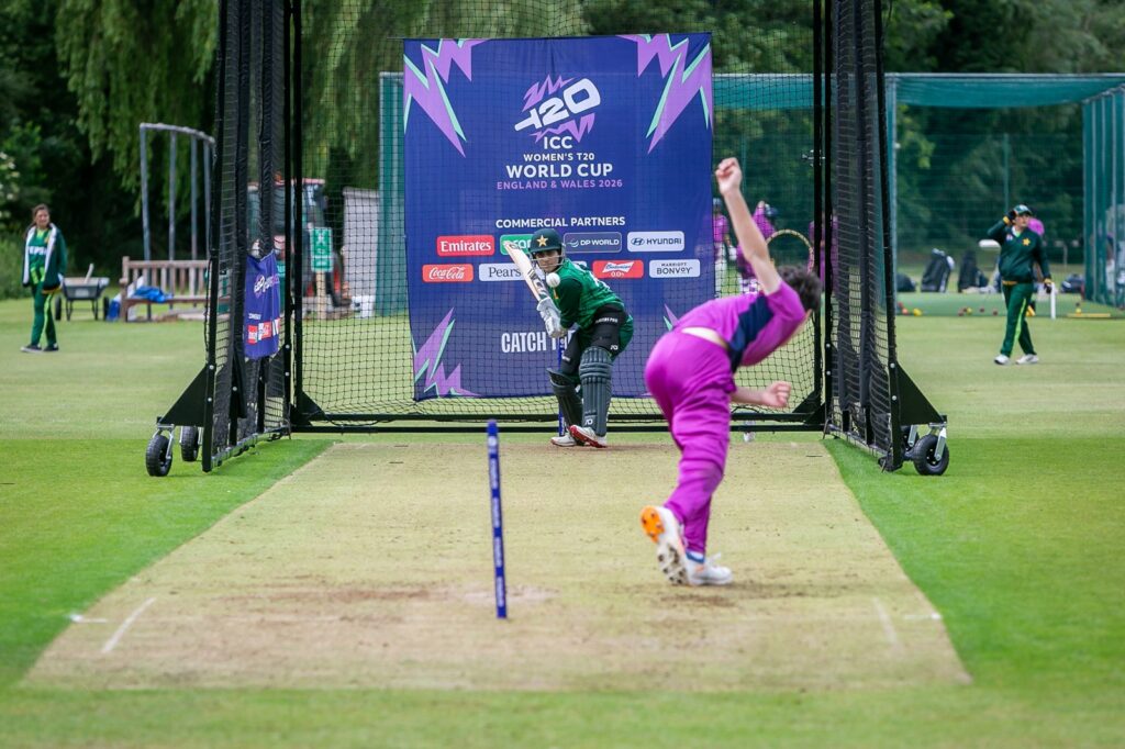 Student in purple net bowling kit bowling at Pakistan player